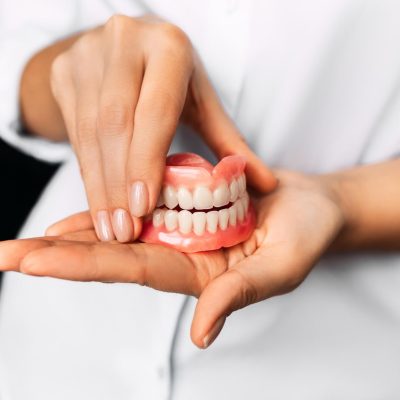 the-dentist-is-holding-dentures-in-his-hands-dental-prosthesis-in-the-hands-of-the-doctor (1)