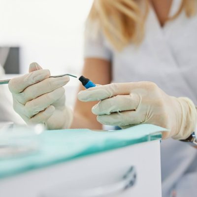woman-reaching-inside-composite-material-bottle-with-dental-carver (1)